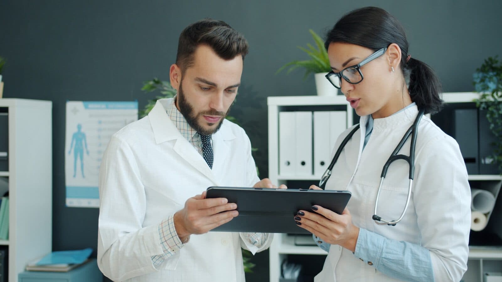 Two doctors looking at a tablet together